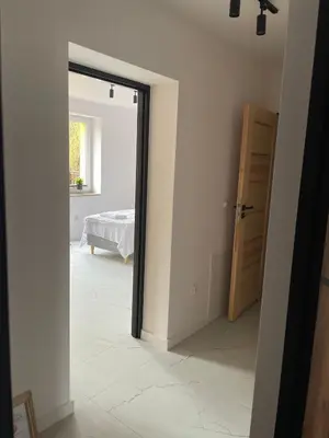 a hallway with a door leading to a bedroom at Hotel Górsko in Wieliczka