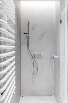 a shower with a glass door in a bathroom at Glossy Apart W21 in Kraków