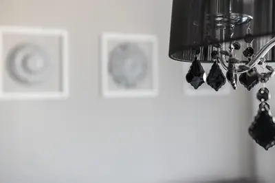 a chandelier in a room with pictures on the wall at Glossy Apart W21 in Kraków