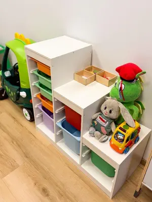 a childs room with a white book shelf and toys at Hotel Kolna - darmowy parking, basen w cenie in Kraków