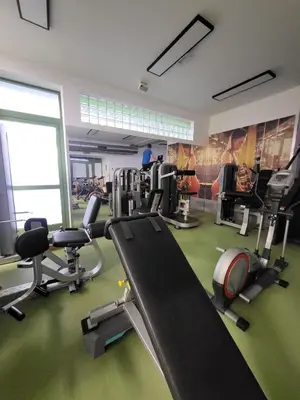 a gym with several treadmills and cardio machines at Hotel Kolna - darmowy parking, basen w cenie in Kraków