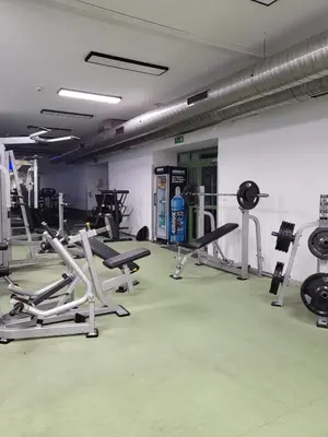 a gym with a lot of treadmills and machines at Hotel Kolna - darmowy parking, basen w cenie in Kraków
