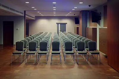 a group of chairs lined up in a room at Hotel Kolna - darmowy parking, basen w cenie in Kraków