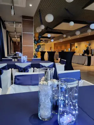 a table with a blue table cloth with glasses on it at Hotel Kolna - darmowy parking, basen w cenie in Kraków