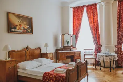 a bedroom with a bed and a table with a mirror at Aparthotel Camea in Kraków