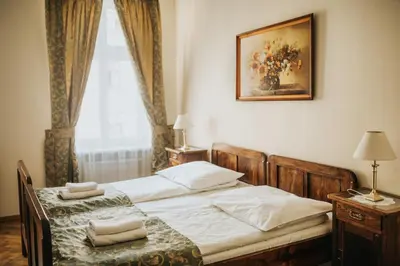 a bedroom with a bed with two towels on it at Aparthotel Camea in Kraków