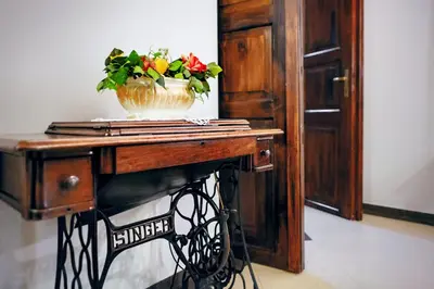 a wooden table with a vase of flowers on it at Aparthotel Camea in Kraków