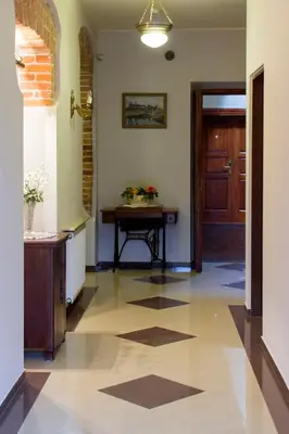 a hallway with a door and a table at Aparthotel Camea in Kraków