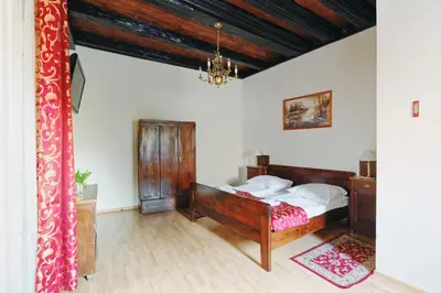 a bedroom with a bed and a chandelier at Aparthotel Camea in Kraków