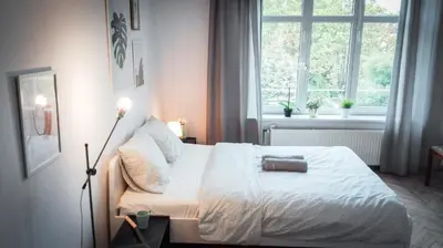 a bedroom with a white bed and a window at LION apartments - SILVER in Kraków