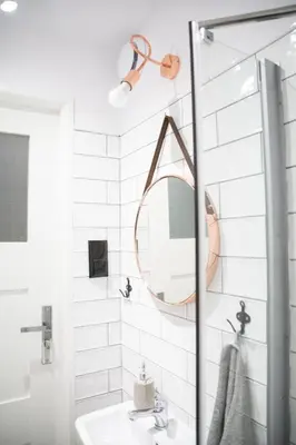 a bathroom with a sink and a mirror at LION apartments - SILVER in Kraków