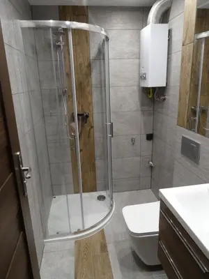 a shower with a glass door in a bathroom at Blue Apartment Oświęcim in Oświęcim
