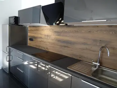 a kitchen with a wooden counter top and a sink at Blue Apartment Oświęcim in Oświęcim