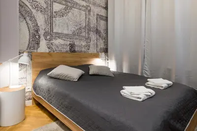 a bedroom with a bed with two towels on it at Welcome Apartment - Old Town in Kraków