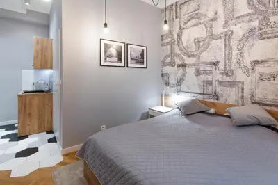 a bedroom with a bed and a wall mural at Welcome Apartment - Old Town in Kraków