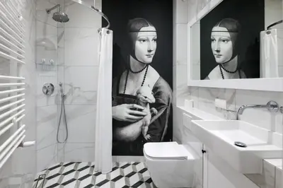 a bathroom with a black and white picture of a man holding a puppy at Welcome Apartment - Old Town in Kraków