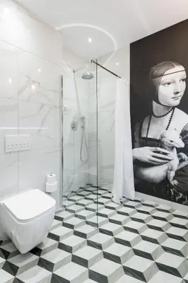 a bathroom with a shower and a toilet and a painting at Welcome Apartment - Old Town in Kraków