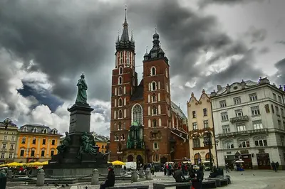 a building with a clock tower in a city at Welcome Apartment - Old Town in Kraków