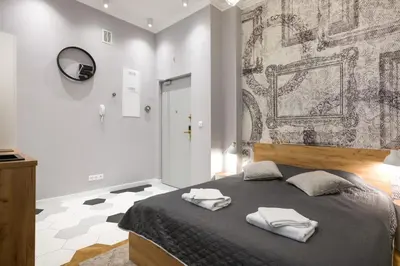 a bedroom with a bed with two towels on it at Welcome Apartment - Old Town in Kraków