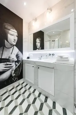 a bathroom with a large painting of a woman holding a baby at Welcome Apartment - Old Town in Kraków
