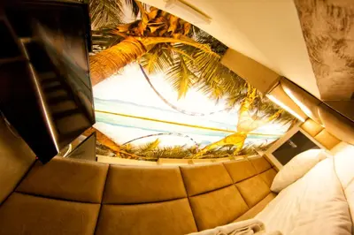 a room with a window with a view of a palm tree at Yourplace XXS Apartments in Kraków