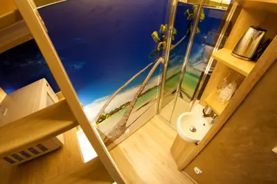 a bathroom with a glass shower with a sink at Yourplace XXS Apartments in Kraków