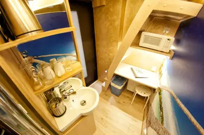 a small bathroom with a sink and a microwave at Yourplace XXS Apartments in Kraków