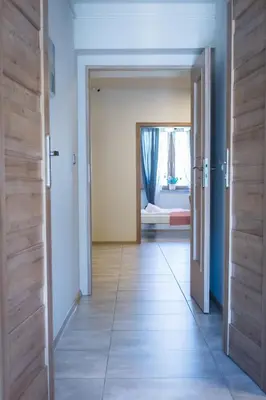 an open door leading to a bedroom with a bed at Harmony Hostel in Zator