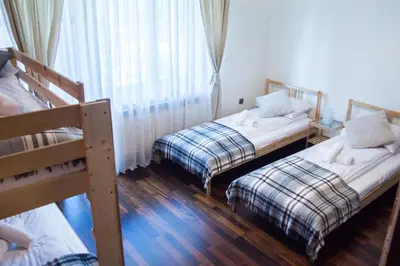 a room with two bunk beds and a window at Harmony Hostel in Zator