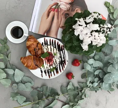 a table with a plate of food and a cup of coffee at Bed&Bath Luxury Apartments in Kraków