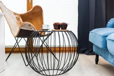a chair and a table in a living room at Bed&Bath Luxury Apartments in Kraków