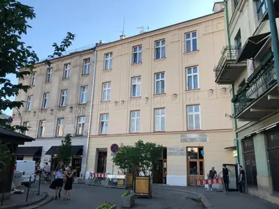a large building with people standing outside of it at Salomea Krakow apartments in Kraków
