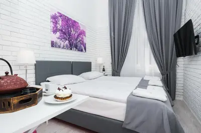 a bedroom with a large bed with a cake on a table at Salomea Krakow apartments in Kraków