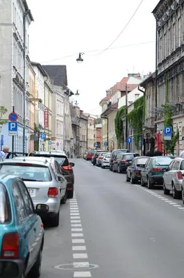 a street with cars parked on the side of the road at Salomea Krakow apartments in Kraków