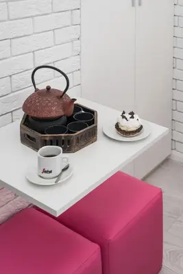 a table with a cup of coffee and a cake at Salomea Krakow apartments in Kraków