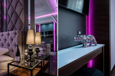 a room with purple lighting and a bar with a couch at Salomea Krakow apartments in Kraków
