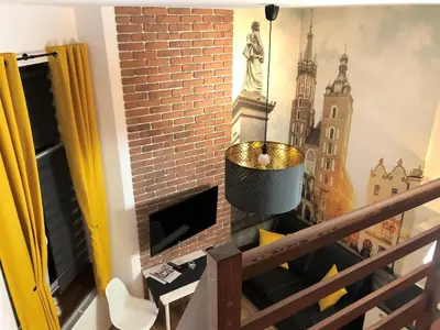 a room with a balcony with a mural of a building at R&R Apart Cracow in Kraków