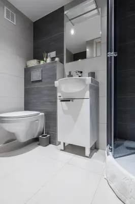 a bathroom with a sink and a toilet and a shower at R&R Apart Cracow in Kraków