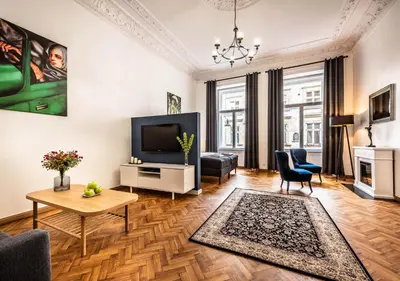 a living room with a television and a table at Flamingo Premium Hostel in Kraków