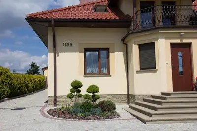 a small house with a staircase and a window at Pokoje Goscinne u Florka in Słopnice