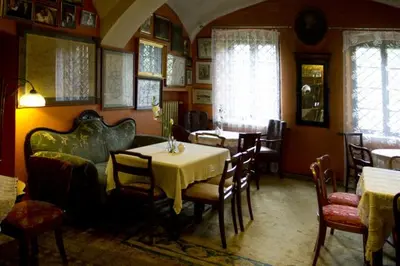 a dining room with a table and some chairs at Austeria Klezmer Hois in Kraków
