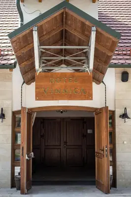 a sign for a hotel in front of a building at Hotel Vinnica in Wieliczka