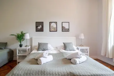a bedroom with a large bed with towels on it at Florianska Gate Luxury Apartments in Kraków