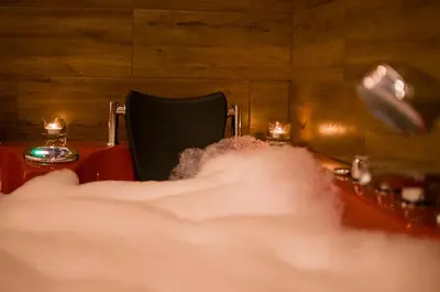 a pile of smoke in front of a table with a chair at Jacuzzi Apartment Red in Kraków