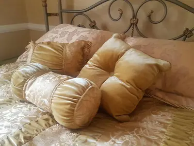 a pile of pillows sitting on top of a bed at GoldStar Luxury Old Town Krakow Apartment in Kraków