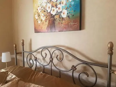a bedroom with a bed with a painting on the wall at GoldStar Luxury Old Town Krakow Apartment in Kraków
