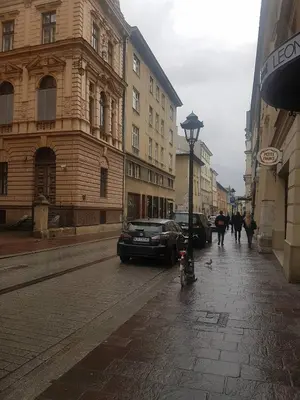 a city street with a car parked on the street at GoldStar Luxury Old Town Krakow Apartment in Kraków