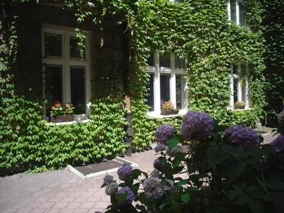a house with flowers in front of a building at Apartament Jonek in Kraków