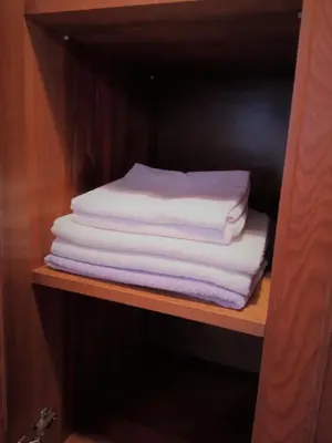 a stack of folded towels on a shelf at Apartament Jonek in Kraków