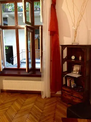 a room with a window and a book shelf at Apartament Berko in Kraków